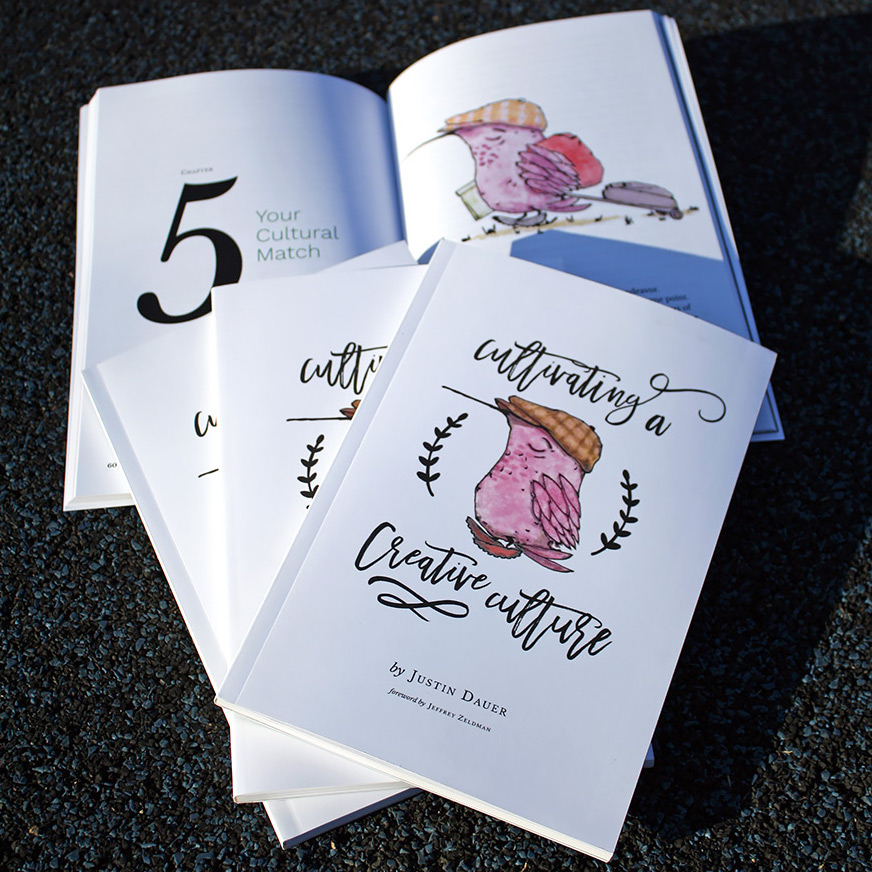 a stack of Cultivating a Creative Culture paperback books